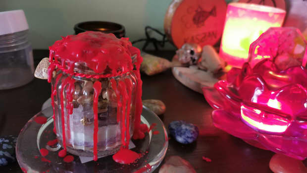 Jar spell sealed with red string and red wax.