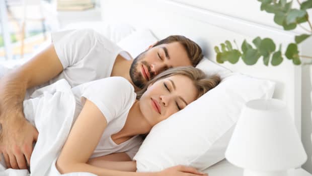 cute young couple sleeping in a bed