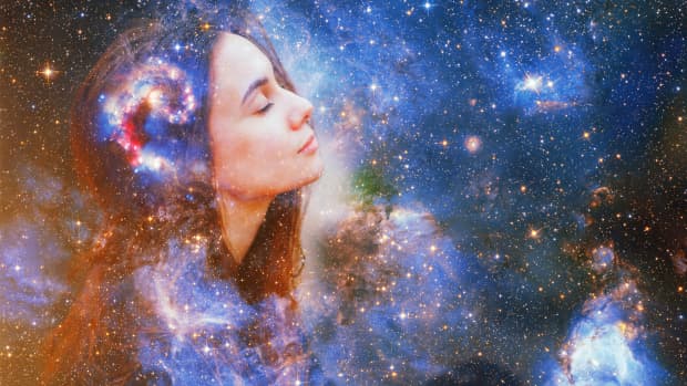 double exposure of a woman's face with a galaxy superimposed over it.