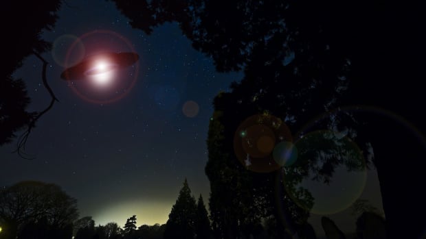 Illustration of a UFO hovering against the night sky.