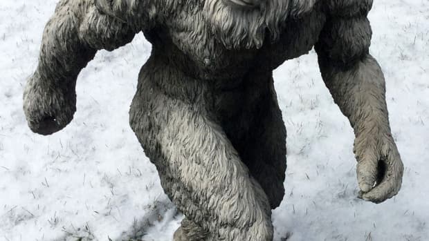 Statue of a yeti in the snow.