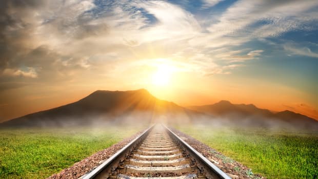 A railroad leading off into a shining sky