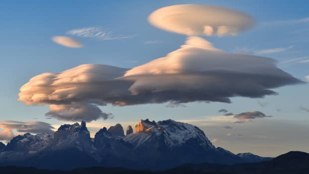 some lenticular clouds over mountains