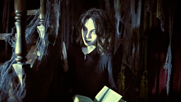 A lonely ghost girl stands in an old abandoned library with a book in her hands.