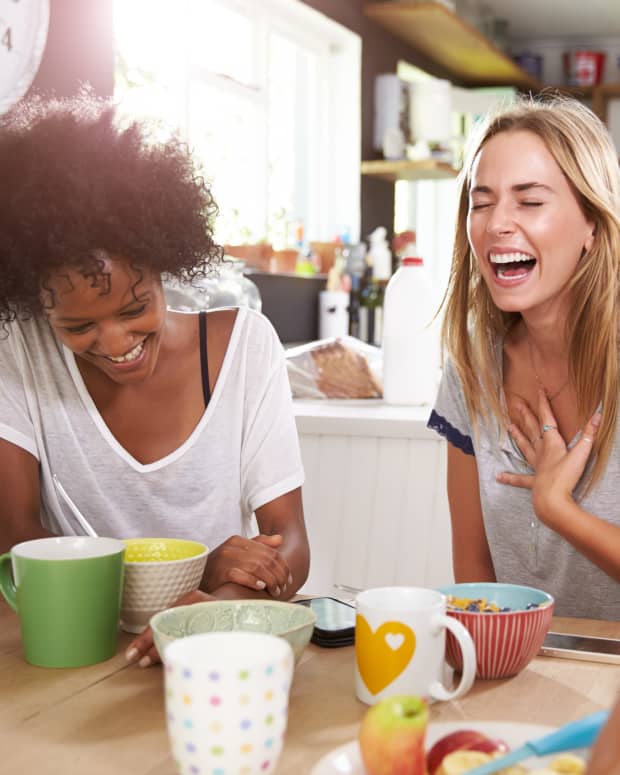 women laughing around table