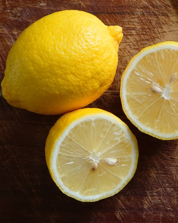 lemons and a knife on a cutting board
