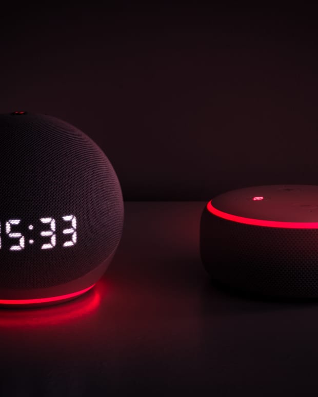 An Amazon Alexa with red glowing lights on a table