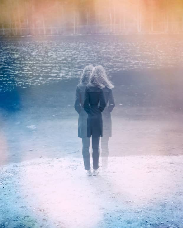 a blurry, double exposed picture of a woman facing away from the camera