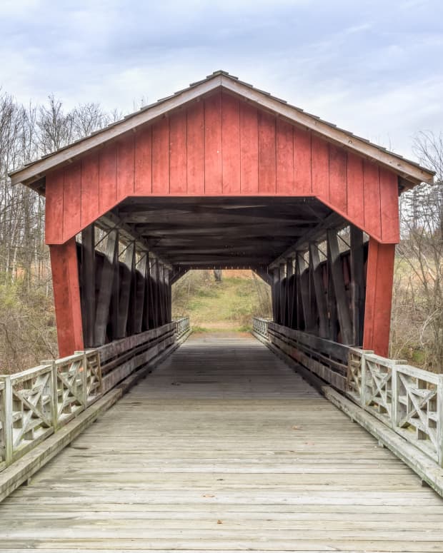 A red covered bridge in the woods