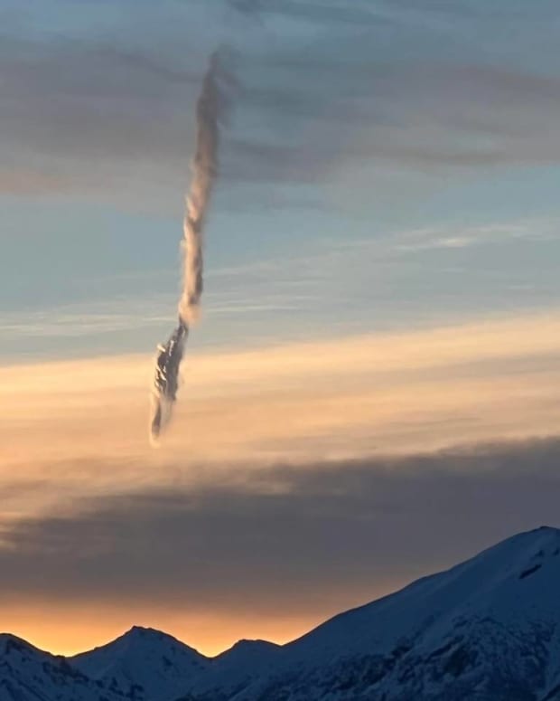 A strange cylindrical cloud over a mountain in Alaska