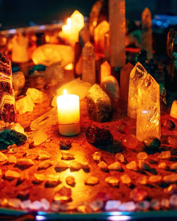 Candles and crystals arranged on an altar