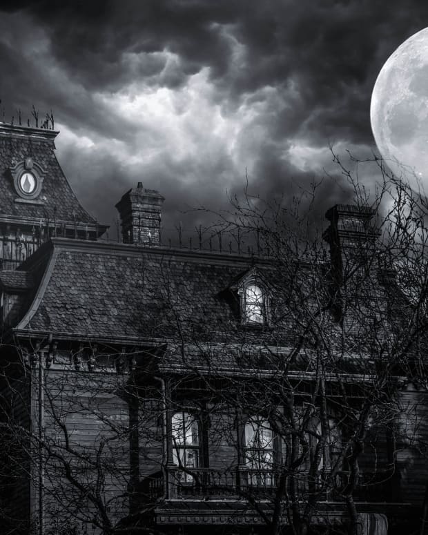 Haunted house under a full moon.