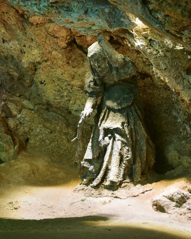 A stone figure of the witch "Mother Shipton" stands inside the cave of petrifying waters which bears her name