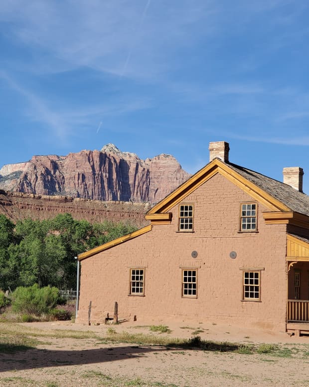 An abandoned building in Grafton, Utah set against the pink cliffs of Zion NP.
