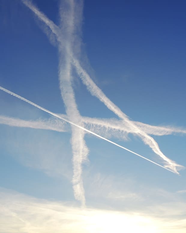 a bunch of crisscrossed contrails in a blue sky