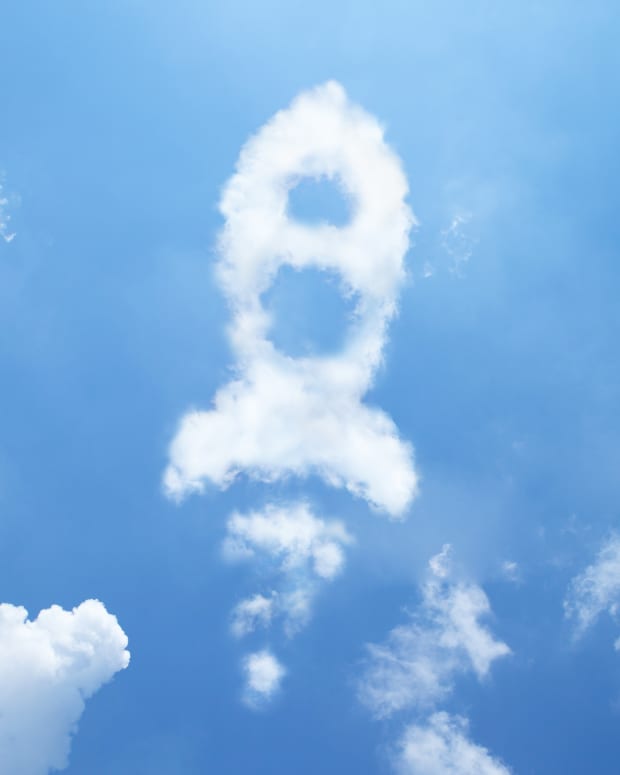 Cloud in the shape of a rocket ship in a blue sky