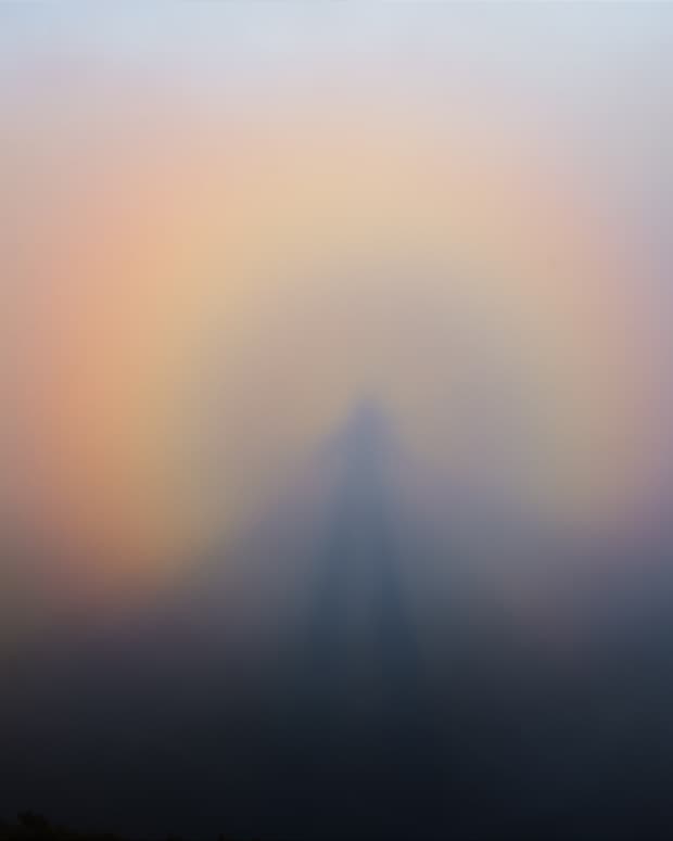 the atmospheric phenomenon known as a Brocken Spectre, a rainbow halo of light around an enormous shadow figure of the observer