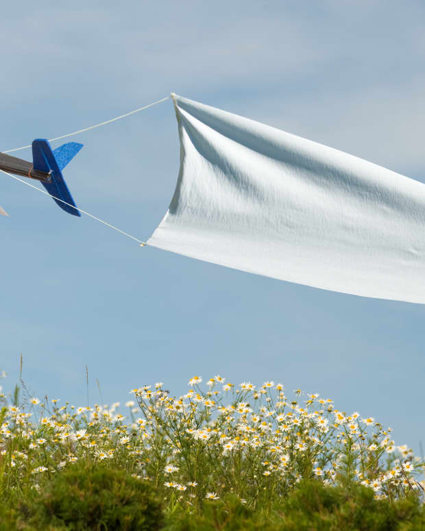 a plane pulling a banner through a blue sky
