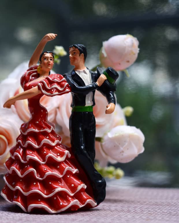 Ceramic Flamenco dancing dolls in front of a bouquet of flowers