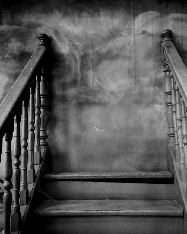 swirling smoke along a bannister and stairs, black and white photo