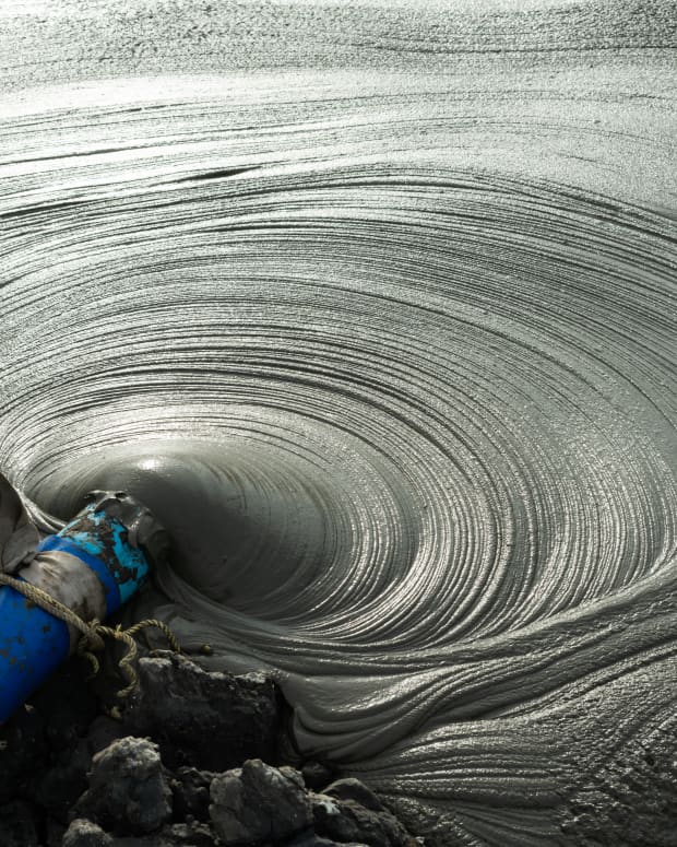 Gray Mud pumping from a pipe
