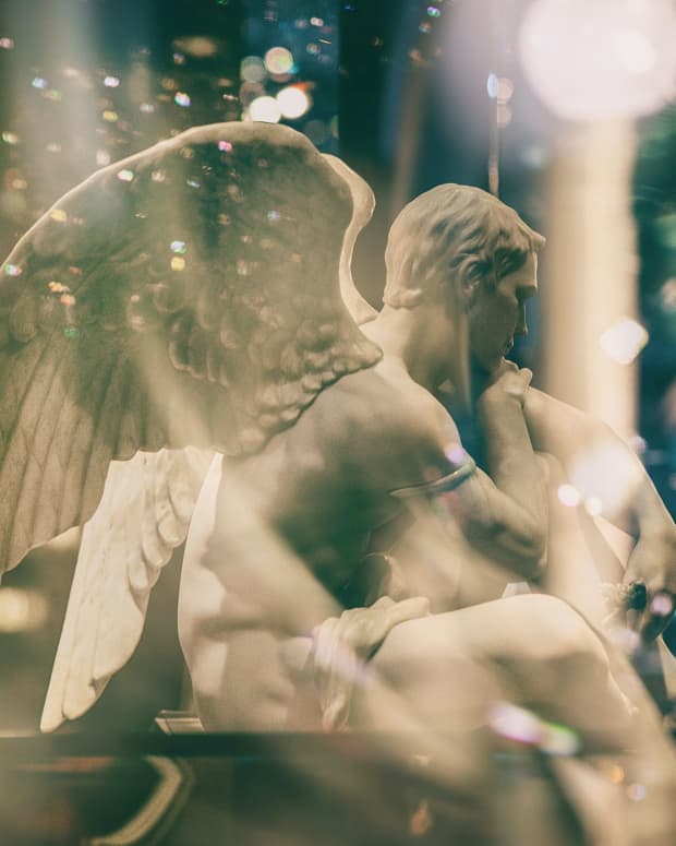 a double exposed picture of an angel statue