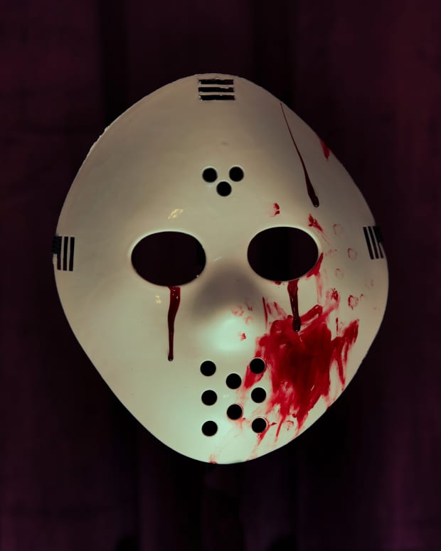 A bloody and scary horror Halloween hockey mask in the style of Jason from Friday 13th movies.