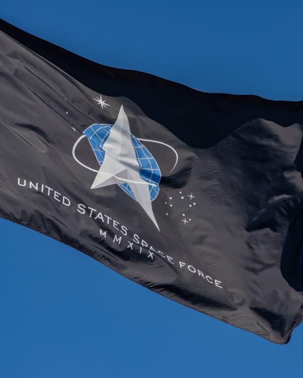 space force flag flying against a blue sky